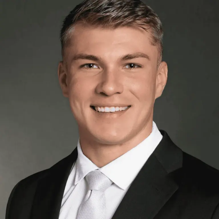 Portrait of Dr. Kyle Harders in a dark suit and white shirt