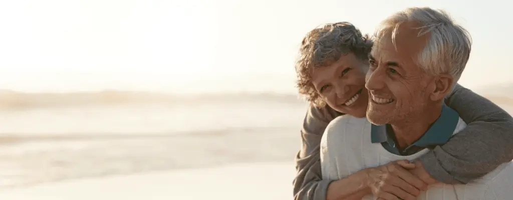 Older couple smiling together outdoors